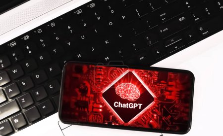 Artificial intelligence text writing concept background with chat gpt on mobile with laptop keyboard