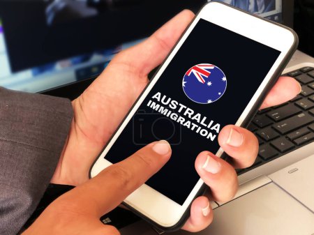 Photo for Australia Immigration concept backdrop with a person using a smartphone for applying online. Immigration to Australia concept background - Royalty Free Image