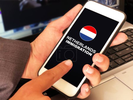 Photo for Man touching applying for the Netherlands immigration on mobile by touching the screen. Netherlands immigration concept background - Royalty Free Image