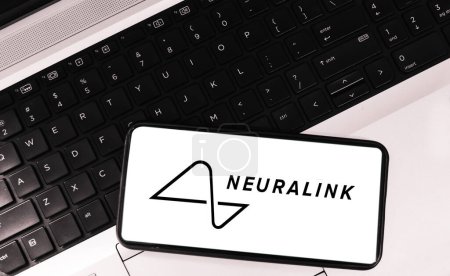 Photo for 30.1.2024. Neuralink company on mobile screen with laptop keyboard in the backdrop. Futuristic tech editorial concept, brain and chip combination technology wallpaper - Royalty Free Image