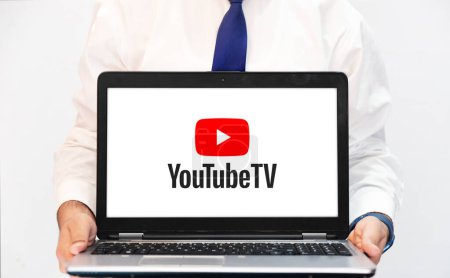 Photo for YouTube TV on the laptop screen held by person for entertainment, editorial background - Royalty Free Image