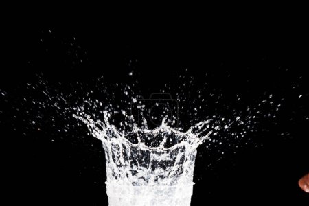 Foto de Splashing water on a black background. water splash refreshing black background - Imagen libre de derechos