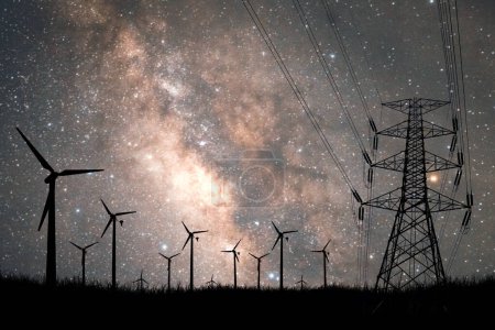 Photo for Silhouette of wind turbine with electricity transmission lines on the background of beautiful sky with stars. - Royalty Free Image