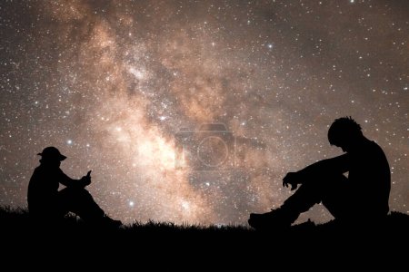 Foto de Hombre solitario, sin esperanza, con el corazón roto. Por la noche, la Vía Láctea y las estrellas son hermosas.. - Imagen libre de derechos