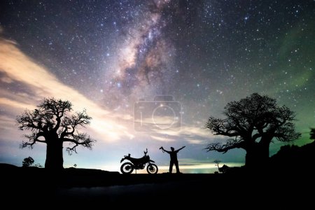 Photo for Silhouette of a man with bike and background of the starry sky - Royalty Free Image
