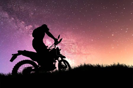 Photo for Man with motocross bike against starry sky in the field - Royalty Free Image