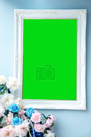 Téléchargez les photos : Cadre blanc vide avec écran vert avec des fleurs - en image libre de droit