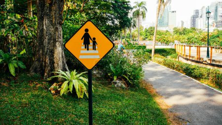 Photo for Warning sign crossing road in public garden - Royalty Free Image