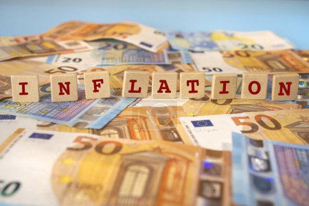 Photo for The word Inflation written on wooden dowels over a background of euro banknotes - Royalty Free Image