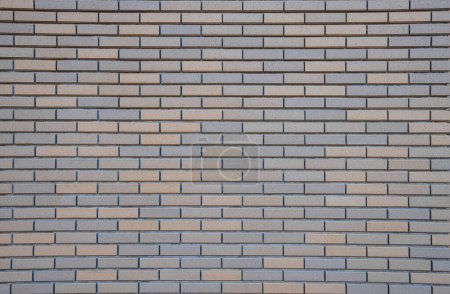 Gray brick wall, wide panorama of masonry, bricklaying texture background.