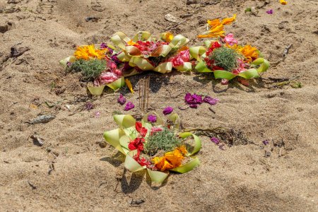 Téléchargez les photos : Offrandes à Dieu selon les croyances hindoues balinaises sur la plage. Une collection de fleurs dans une feuille en forme. Connu sous le nom de "Canang" - en image libre de droit