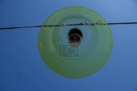 Photo for Incandescent lamp with wires running above it and a blue sky background. Nice illustration for electricity - Royalty Free Image