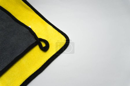Photo for Yellow black towel on a black background - Royalty Free Image