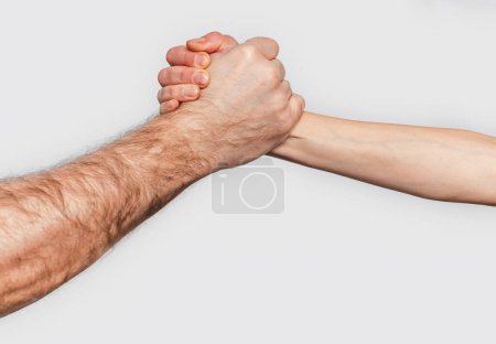 Photo for Man and woman with clasped hands engage in arm wrestling. Gray background. Struggle man and woman - Royalty Free Image