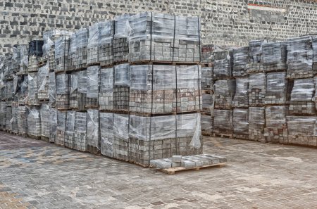 Photo for Interior of production warehouse. Plant for production of paving slabs. Cobblestones are piled up - Royalty Free Image