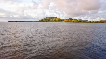 Drone view of the Fiji Islands. Ocean waters. Clouds over the islands. Vacation and travel concept