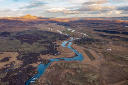 Picturesque aerial view winding river flowing through meadow in spring. Sunset. Borgarnes Iceland