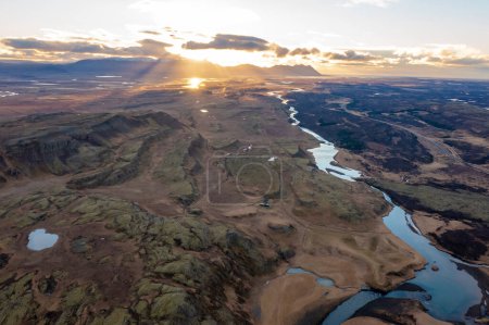 Picturesque aerial view winding river flowing through meadow in spring. Sunset. Borgarnes Iceland