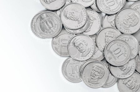 Ukrainian money, exchange coin, white coins denomination of 10 hryvnias in random order. Copy space