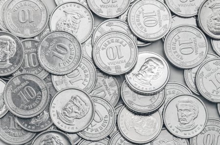 Ukrainian money, exchange coin, white coins denomination of 10 hryvnias in random order. Top view