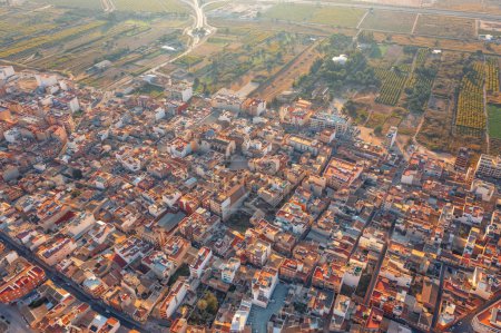 From high above, the ancient city sprawls like a labyrinth of miniature dwellings, each one snug against its neighbor, forming a patchwork of rooftops that stretch to the horizon.
