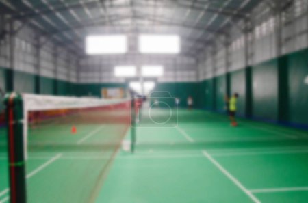 Athletes who are playing badminton in the badminton court, blurred image.