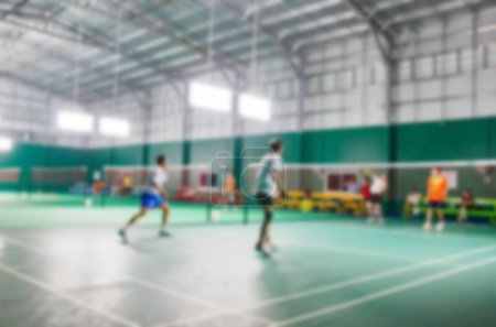 Photo for Athletes who are playing badminton in the badminton court, blurred image. - Royalty Free Image