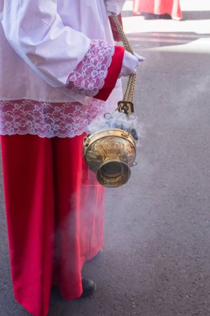 Photo for Madrid, Spain; April 2, 2023: Holy Week Procession on Palm Sunday. Close-up of an altar boy moving the incense burner. - Royalty Free Image