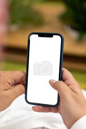 Close-up of Hand Holding Modern Smartphone. High quality photo The image shows a person holding a smartphone. The persons hand is positioned in the center of the image, and their fingers are gently