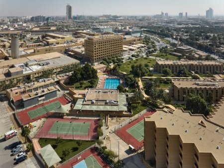 Photo for City Swimming Pool and Tennis Courts from Above. High quality photoThis aerial photograph captures a city rooftop recreation complex, featuring a swimming pool and several tennis courts. The - Royalty Free Image