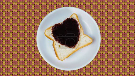Photo for Top View of Heart Shape Cutted Bread and Filled with Chocolate Sauce in White Dish, on Table Mate - Royalty Free Image