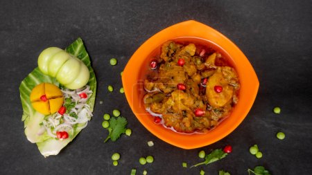 Photo for Mix Vegetables Gujarati Rasia Muthiya in Orange Bowl, Green Tomato, Lime, Pomegranate Seeds, Onion Slices, Cabbage With Peas - Royalty Free Image