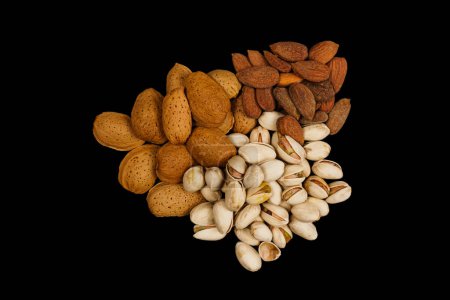 Photo for Mix pistachios ,cardamom and peeled, unpeeled almonds with isolated black background - Royalty Free Image