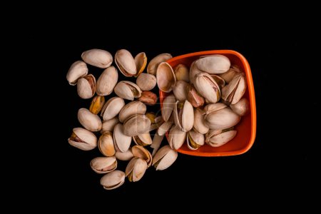 Photo for Pistachio nuts with black background - Royalty Free Image