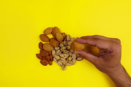 Photo for Mix pistachios ,cardamom and peeled, unpeeled almonds with isolated black background - Royalty Free Image