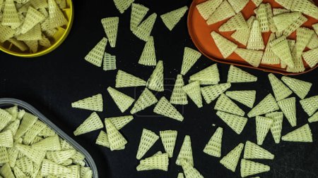 Photo for Triangle shape Fryums crunchy Snacks in black background - Royalty Free Image