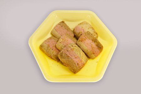 Photo for Many Square Nankhatai in Yellow Hexagon Plate - Royalty Free Image