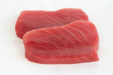 Raw yellow fin tuna (Thunnus albacares) fish steak on white background