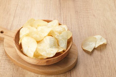 Keripik Singkong or Cassava Chips, Indonesian traditional snack. Served in bowl on wooden background.