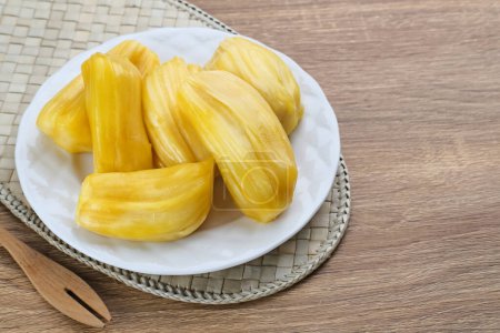 Photo for Fresh and ripe jackfruit served on a plate on a wooden table. - Royalty Free Image