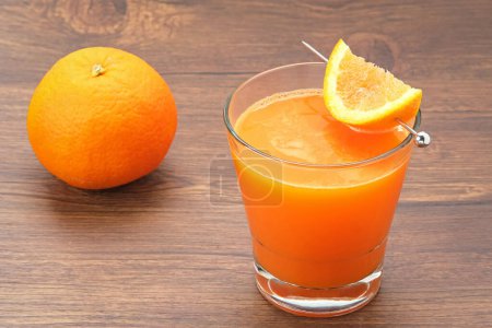 Photo for Orange juice in glass, cold pressed juice with fresh fruits on wooden table - Royalty Free Image
