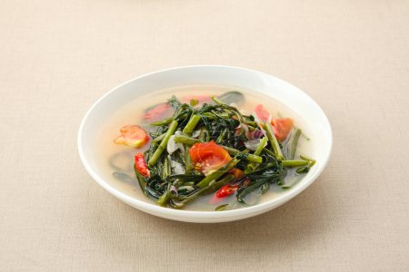 Tumis Kangkung or Ca Kangkung, Indonesian food. Served on white plate