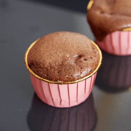 Photo for Chocolate Souffle in a Round Pink Paper Cup with Gold Rim - Royalty Free Image