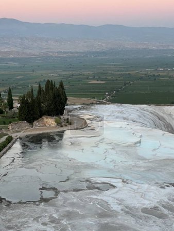 View of the Travertine terraces on the sunset in Pamukkale, Turkey, where the stunning landscape showcases the natural wonder of calcium deposits and mineral formations