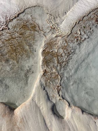 Textures of the travertine terraces in Pamukkale, Turkey, where the mesmerizing patterns and formations of calcium deposits create a unique and surreal landscape
