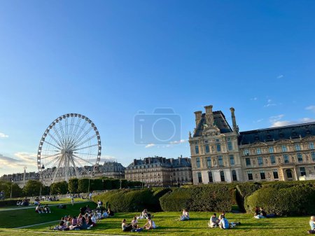 Photo for People relax on the grass at Tuileries garden, Paris, France - Royalty Free Image