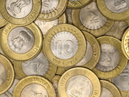 Photo for A mixed collection of rare vintage indian bimetallic 10 (ten) rupee coins gold and silver in a pile - Royalty Free Image
