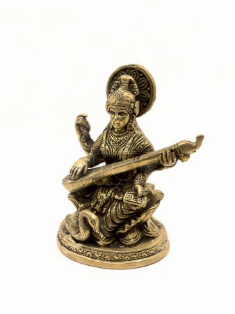 Photo for Brass statue of saraswathi devi, goddess of knowledge, art, music, nature and wisdom sitting on a lotus near a swan playing veena instrument - Royalty Free Image