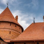 View of the red tiled roof and red brick masonry of the towers of Trakai Castle, Trakai, Lithuania.