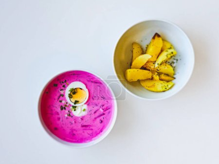Cold Lithuanian soup Saltibarsciai, a cold summer soup made of beetroot and kefir, popular in Lithuania, Latvia, Poland and Belarus, served with baked potatoes.